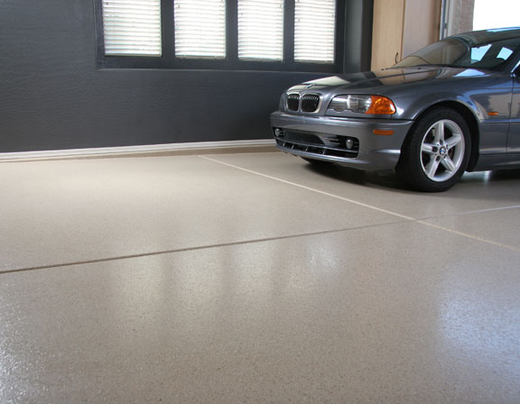 This image shows a garage floor with flake epoxy that is cream in color.