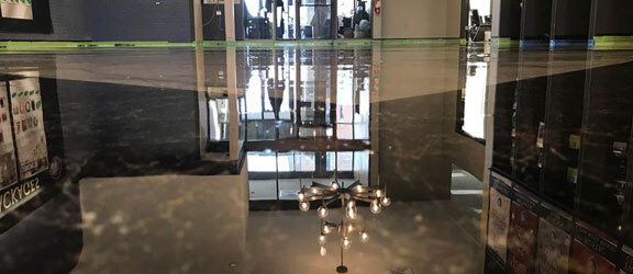 Metallic Epoxy This image show a commercial floor with epoxy that is shiny black in color.