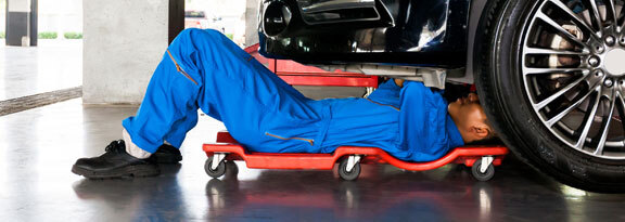 Epoxy Industrial Flooring This image shows a mechanic working on a car.