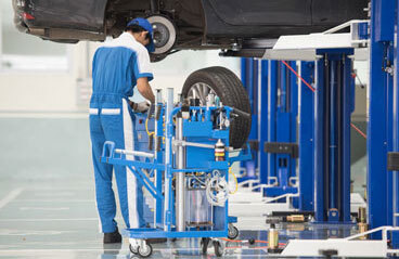 Garage Epoxy This image shows a mechanic working on a car.