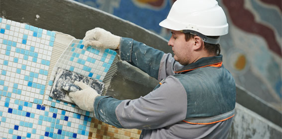 This shows an image of a man putting pool tiles.