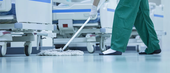 This image shows a man mopping the hospital floor.
