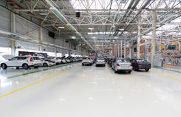 This image shows a vehicle manufacturing plant that has a white epoxy floor.