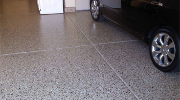 This image shows a garage floor with flake epoxy that is cream in color.