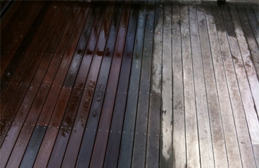 This image shows a wooden deck that is being resurfaced.