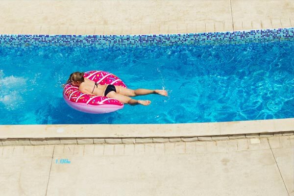 pool-repair-one This image shows a woman swimming in a pool.