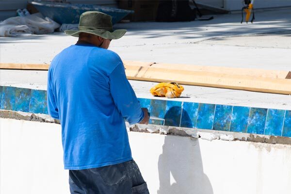 pool-repair-one This shows an image of a man putting pool tiles.