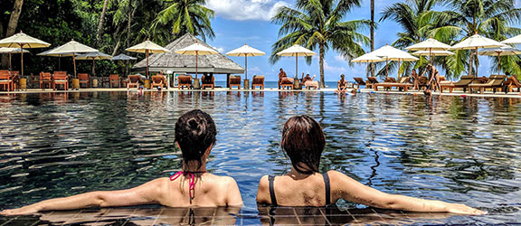 This image shows 2 women at a swimming pool.